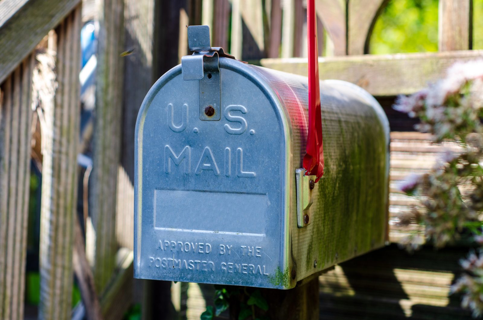 Classic U.S. Mail curbside mailbox with the red flag raised
